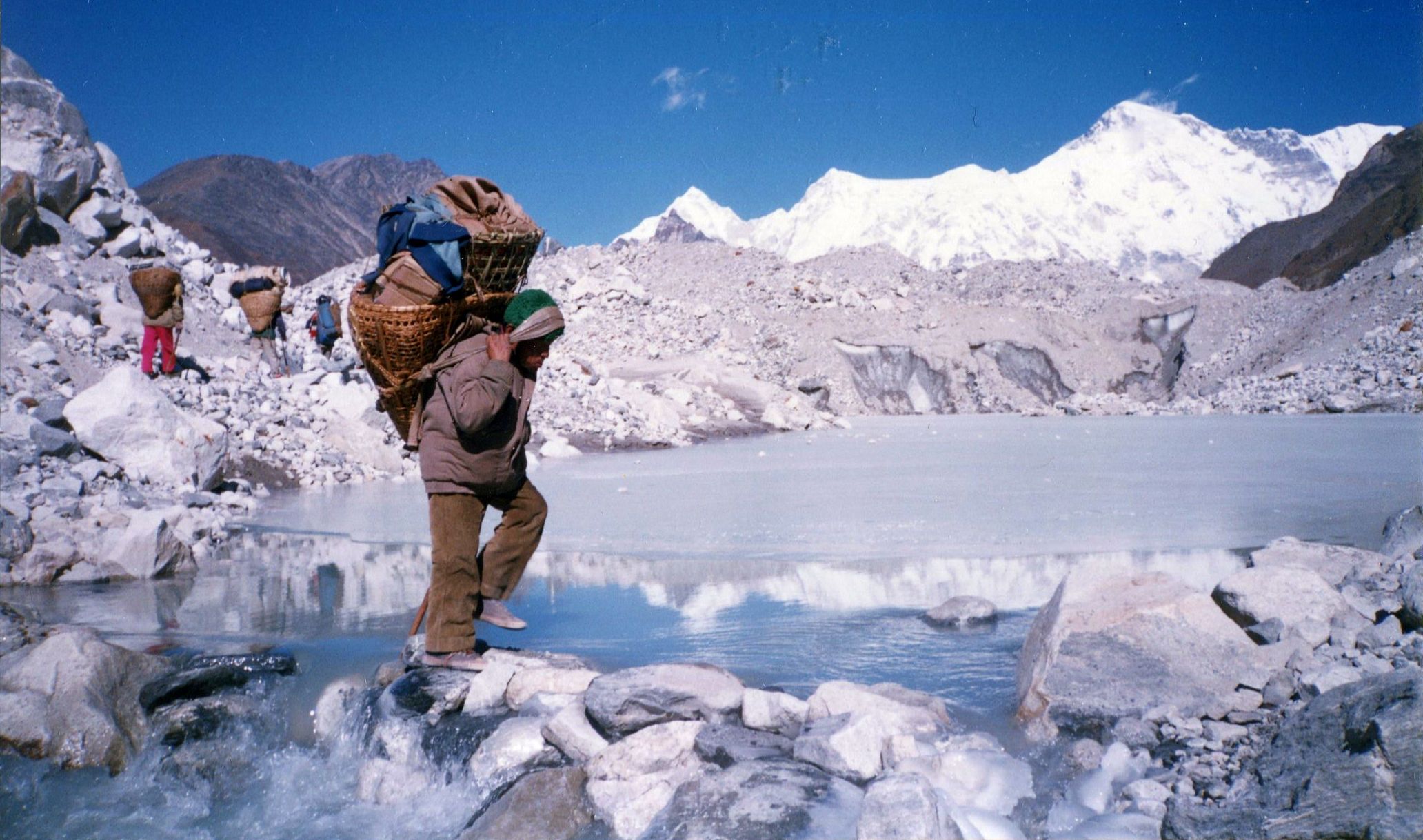 Porter Crossing Ngozumpa Glacier on route to Gokyo