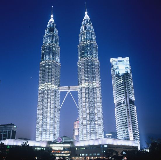 Petronas Towers illuminated at night in Kuala Lumpur