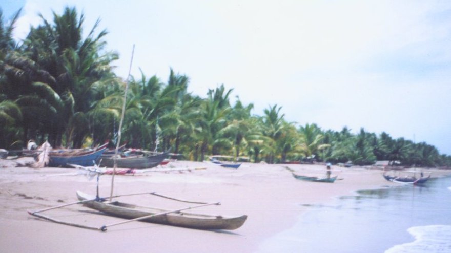 Out-rigger Fishing boat on beach near Padang on Sumatra